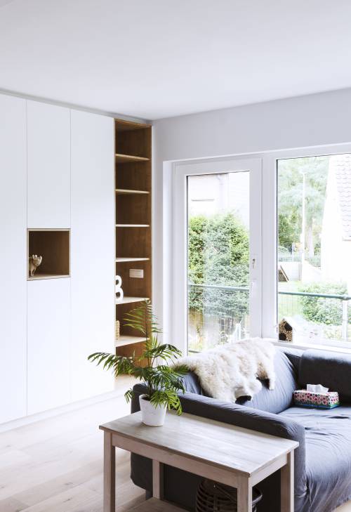 Moderne woonkamer met een strak design, een zachte bank en een minimalistische stijl.